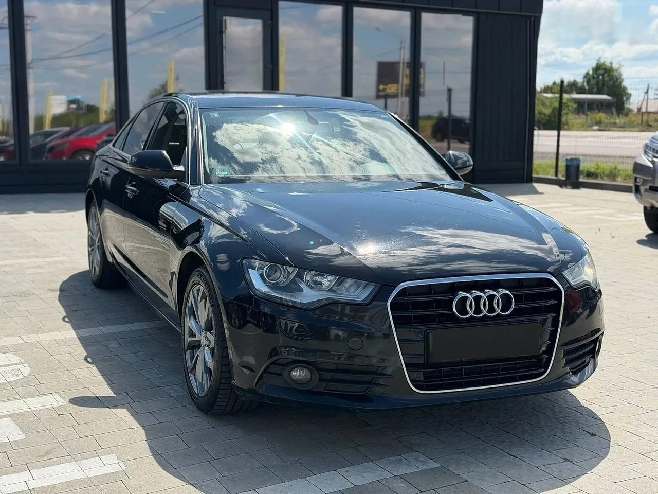 Audi A6 2011 — чорний седан, вигляд спереду збоку