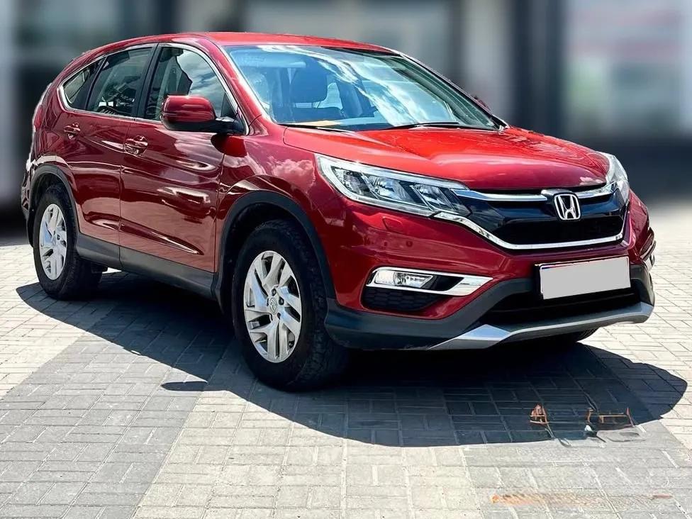 Honda CR-V 2016 — червоний кросовер, вигляд спереду збоку
